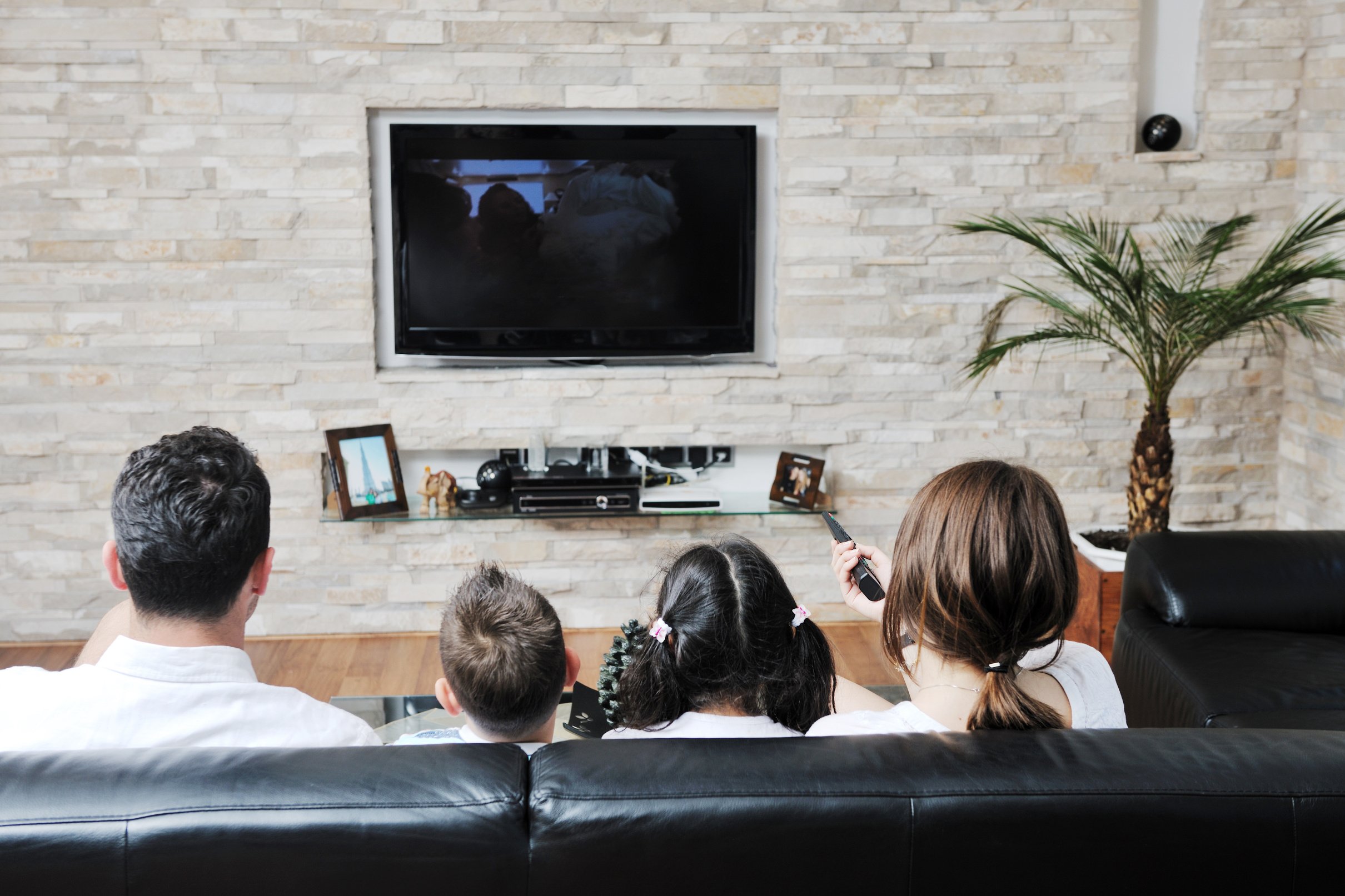 Family Watching TV in Living Room